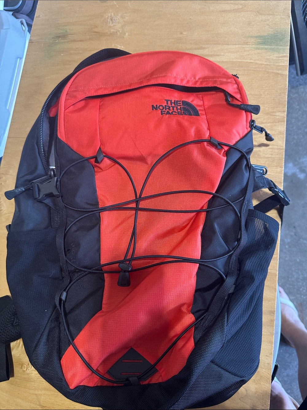 The North Face Red and Black Menโs Backpack with Bungee Front